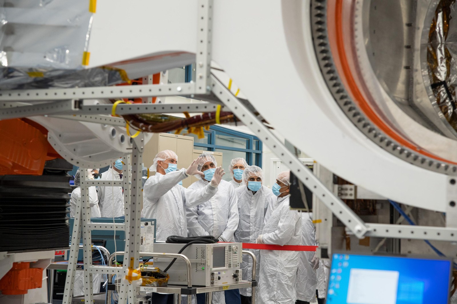 ISRO scientists with the NISAR satellite in a clean room